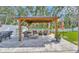 Outdoor patio area featuring a gazebo with outdoor seating and a TV, perfect for entertaining guests at 12965 Satin Lily Dr, Riverview, FL 33579