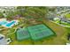 Aerial view of community tennis and basketball courts near a playground and swimming pool at 12965 Satin Lily Dr, Riverview, FL 33579