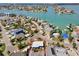 Aerial view of charming waterfront community, showcasing the home's proximity to the bay and neighborhood amenities at 13098 Boca Ciega Ave, Madeira Beach, FL 33708