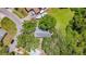 An aerial view showcases the home surrounded by mature trees in a quiet neighborhood at 1444 Oak Haven Dr, Safety Harbor, FL 34695