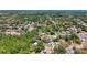 Aerial view showcases a neighborhood setting near the water, with houses nestled among trees and landscaping at 1444 Oak Haven Dr, Safety Harbor, FL 34695