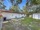 View of the backyard with a shed, grassy area and the back of the house at 1444 Oak Haven Dr, Safety Harbor, FL 34695