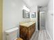 Bathroom with wood-style vanity, decorative mirror, and tile flooring at 1444 Oak Haven Dr, Safety Harbor, FL 34695