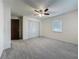 Cozy bedroom with soft carpet, a modern ceiling fan, and a spacious double door closet at 1444 Oak Haven Dr, Safety Harbor, FL 34695