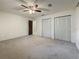 Spacious bedroom features neutral carpeting, ceiling fan, and ample closet space at 1444 Oak Haven Dr, Safety Harbor, FL 34695