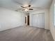 Inviting bedroom with neutral carpet, modern ceiling fan, and a double door closet at 1444 Oak Haven Dr, Safety Harbor, FL 34695
