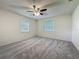 Spacious bedroom with neutral walls, plush carpet, and modern ceiling fan at 1444 Oak Haven Dr, Safety Harbor, FL 34695