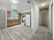Well-lit kitchen with light wood-look cabinets, white appliances, and wood-look flooring at 1444 Oak Haven Dr, Safety Harbor, FL 34695