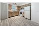 Functional kitchen with light wood-look cabinets, white appliances, wood-look flooring and plenty of natural light at 1444 Oak Haven Dr, Safety Harbor, FL 34695