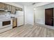 Bright kitchen with wooden cabinets, white appliances, and durable wood-look flooring at 1444 Oak Haven Dr, Safety Harbor, FL 34695