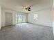 Neutral living room with neutral carpet, a ceiling fan, a front entry door, and a bay window at 1444 Oak Haven Dr, Safety Harbor, FL 34695