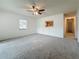 Bright living room featuring neutral carpet, a ceiling fan and natural light from the exterior windows at 1444 Oak Haven Dr, Safety Harbor, FL 34695