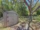 Outdoor view of a metal garden shed, trees and the surrounding yard at 1444 Oak Haven Dr, Safety Harbor, FL 34695