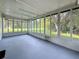 Enclosed sunroom with floor-to-ceiling windows offering bright natural light at 1444 Oak Haven Dr, Safety Harbor, FL 34695
