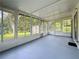 Enclosed sunroom features natural light and backyard views at 1444 Oak Haven Dr, Safety Harbor, FL 34695