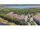 Aerial view of complex surrounded by lush trees and near a beautiful lake at 1610 Raena Dr # 204, Odessa, FL 33556