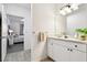 Bright bathroom featuring tiled floors, vanity with mirror and neutral paint at 1610 Raena Dr # 204, Odessa, FL 33556