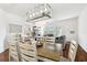 Open dining room with wood table and decorative light fixture at 1610 Raena Dr # 204, Odessa, FL 33556
