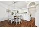 Elegant dining room with modern lighting, stylish table, and an open view to the kitchen at 1610 Raena Dr # 204, Odessa, FL 33556