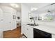 Bright kitchen space with white cabinets, laminate countertops, stainless sink, and laminate floors at 1610 Raena Dr # 204, Odessa, FL 33556