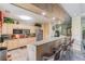 Open kitchen with stainless appliances, light wood cabinets, granite counters and bar seating at 1610 Raena Dr # 204, Odessa, FL 33556