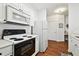 Bright kitchen with white appliances, ample counter space, and stylish flooring at 1610 Raena Dr # 204, Odessa, FL 33556