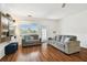 Bright living room featuring a large window with nice outdoor views, a sofa, and laminate floors at 1610 Raena Dr # 204, Odessa, FL 33556