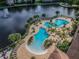 Beautiful pool area with multiple pools, palm trees, and lounge chairs at 1610 Raena Dr # 204, Odessa, FL 33556