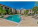 Exterior view of a sparkling pool with lush landscaping and inviting lounge chairs in a great community at 1610 Raena Dr # 204, Odessa, FL 33556