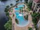 Stunning aerial view of the community pools surrounded by lush tropical landscaping and palm trees at 1610 Raena Dr # 204, Odessa, FL 33556