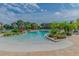 A luxurious zero entry pool with lush tropical landscaping and ample lounge seating by the water at 1610 Raena Dr # 204, Odessa, FL 33556