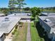 A well-maintained community from above shows manicured lawns and mature landscaping and a tranquil pond at 201 Kings Blvd # 19, Sun City Center, FL 33573