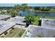 An aerial view showing a manicured community with mature trees surrounding a lake and lovely landscaping at 201 Kings Blvd # 19, Sun City Center, FL 33573