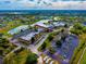 Aerial view of Kings Point community featuring landscaping, lake and parking at 201 Kings Blvd # 19, Sun City Center, FL 33573