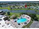 Community aerial view of the pool and amenities near a lake at 201 Kings Blvd # 19, Sun City Center, FL 33573