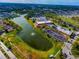 Scenic aerial view of Kings Point showing lake, recreation, clubhouse and landscaping at 201 Kings Blvd # 19, Sun City Center, FL 33573