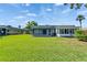 Lush green backyard with screened patio and access to the building at 201 Kings Blvd # 19, Sun City Center, FL 33573