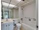 Bathroom with vanity, toilet, bathtub, and shower with handrails at 201 Kings Blvd # 19, Sun City Center, FL 33573