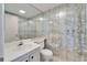 Bathroom featuring a single vanity, toilet, mirrored wall, and wallpaper at 201 Kings Blvd # 19, Sun City Center, FL 33573