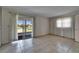 Neutral bedroom with tile flooring and sliding glass door access to outdoor patio at 201 Kings Blvd # 19, Sun City Center, FL 33573