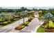 Well-maintained community entrance with manicured landscaping, palm trees, and an American flag at 201 Kings Blvd # 19, Sun City Center, FL 33573