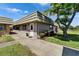 Charming single-story home boasts well-maintained landscaping and a welcoming entrance, enhancing its appeal at 201 Kings Blvd # 19, Sun City Center, FL 33573
