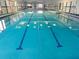 Bright indoor swimming pool with clear water, marked lanes, and large windows at 201 Kings Blvd # 19, Sun City Center, FL 33573