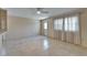 Bright living room with tile flooring, ceiling fan, and natural light from large windows at 201 Kings Blvd # 19, Sun City Center, FL 33573