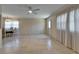 Bright living room with tile flooring, ceiling fan, and natural light from large windows at 201 Kings Blvd # 19, Sun City Center, FL 33573