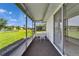 Spacious screened patio with table and chairs overlooks landscaped backyard at 201 Kings Blvd # 19, Sun City Center, FL 33573