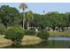 Lush landscaping surrounds a serene pond, creating a peaceful atmosphere at 201 Kings Blvd # 19, Sun City Center, FL 33573