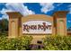 Kings Point community sign with manicured landscaping underneath a blue sky with fluffy clouds at 201 Kings Blvd # 19, Sun City Center, FL 33573