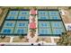 Aerial shot of tennis courts surrounded by lush landscaping and well-maintained walkways at 201 Kings Blvd # 19, Sun City Center, FL 33573