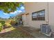 Backyard patio area with greenery, potted plants, and an AC unit at 2131 Ridge S Rd # 130, Largo, FL 33778